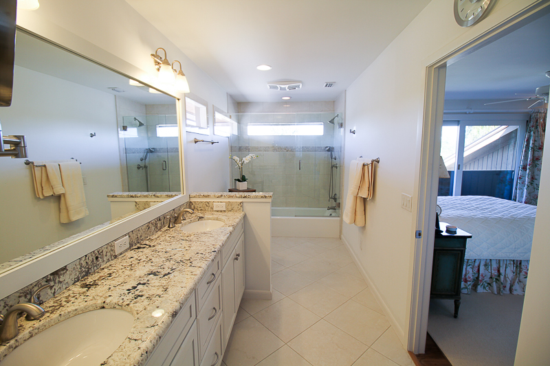 An 18 x 18 tile was installed on a diagonal to create a larger room feel. This large vanity area shows a Delicatus Granite top and back splash.