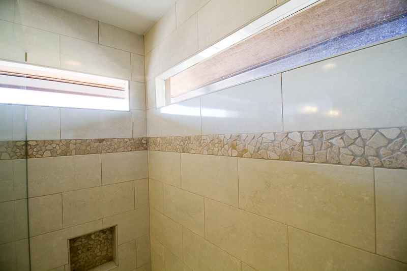 This tub shower combination shows a sliced natural stone as an accent to the tile.