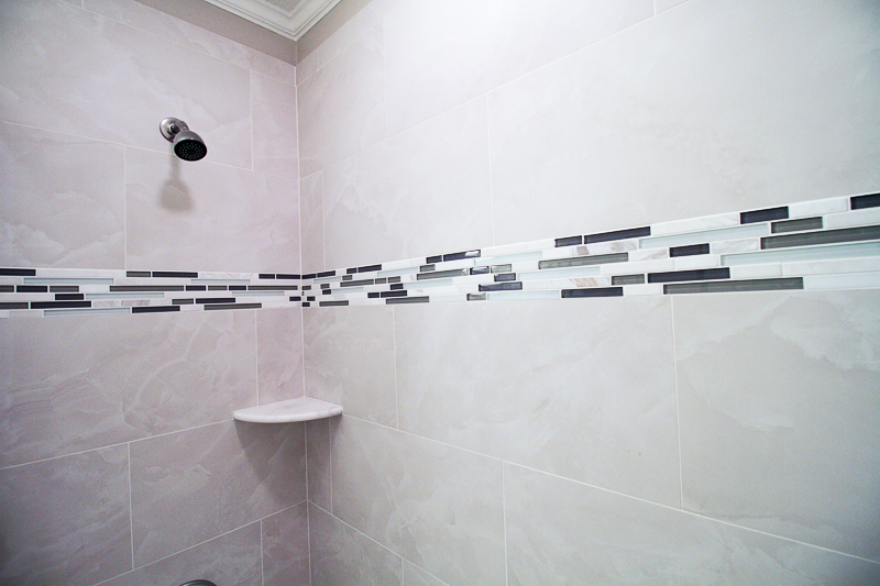 White Onyx 12 x 24 porcelain tile with an icy look in this tub surround.