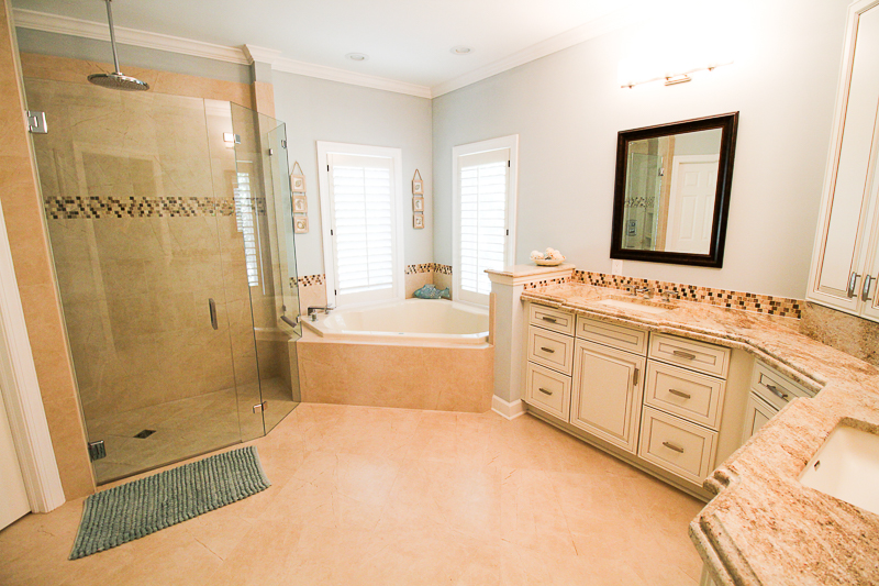 This granite counter top has a 2 piece edge for a much deeper look. Look into the custom walk in shower with no curb. It boasts a large rain shower head from the ceiling with frameless glass shower enclosure .