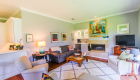 Crown moulding at the ceiling shows well with the large baseboards in this living room with wet bar.
