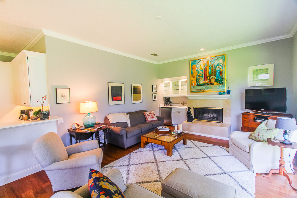 Crown moulding at the ceiling shows well with the large baseboards in this living room with wet bar.