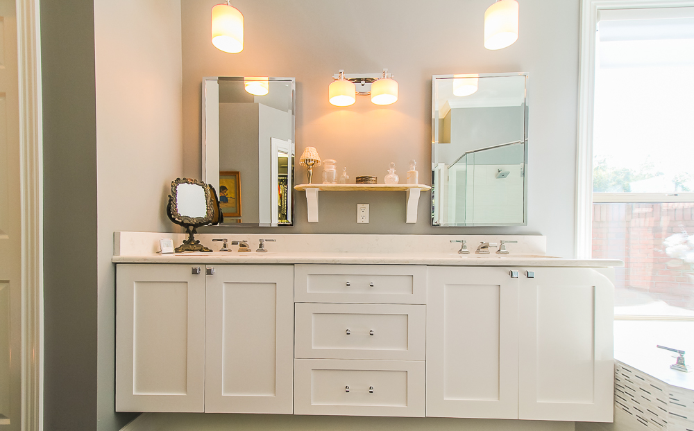 The combination of pendant and sconce lighting is used on this double sink vanity.