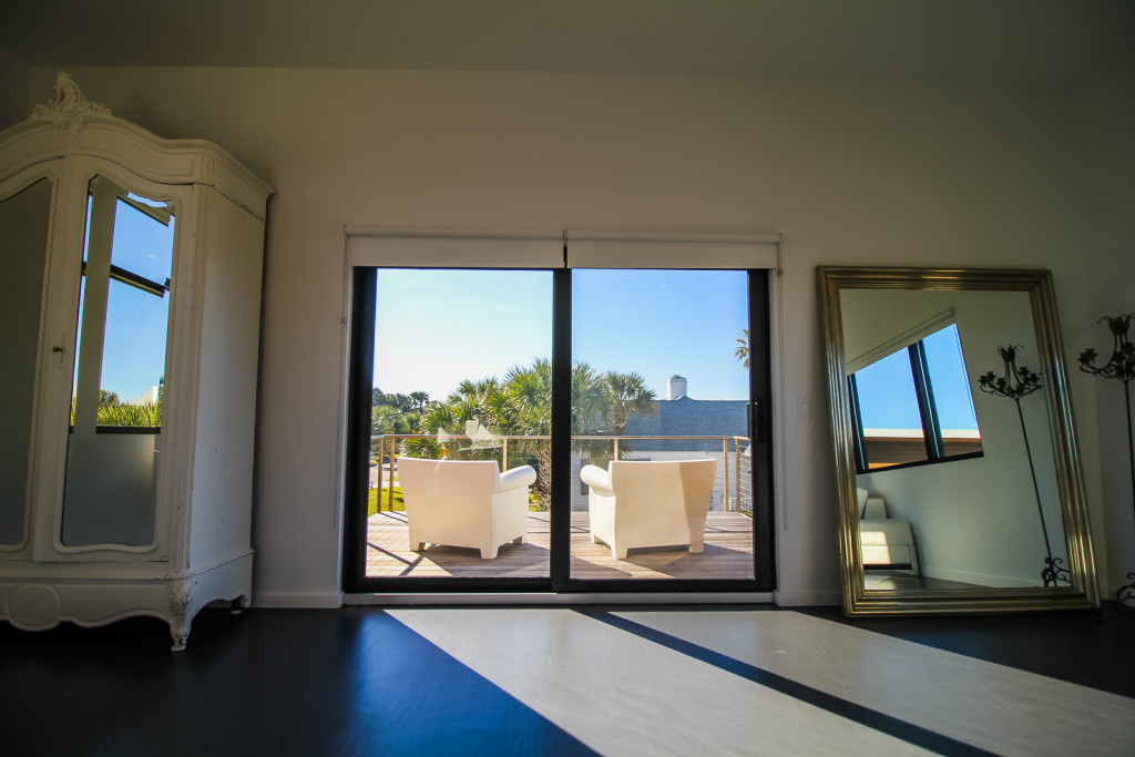 This shows the use of narrow framed sliding doors with impact resistant glass for wind storms and flying debris.